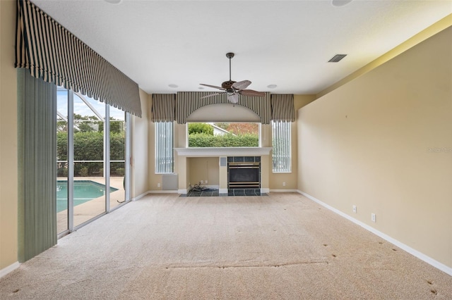6112 Kinlock Ave, Spring Hill, FL 34608 - unfurnished living room with carpet flooring, a fireplace, baseboards, and healthy amount of natural light