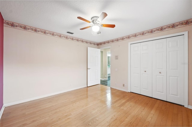 6112 Kinlock Ave, Spring Hill, FL 34608 - unfurnished bedroom with light wood finished floors, baseboards, a closet, and a ceiling fan