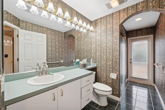 6112 Kinlock Ave, Spring Hill, FL 34608 - bathroom featuring wallpapered walls, tile patterned floors, toilet, vanity, and baseboards