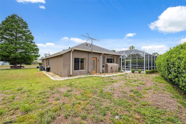 6112 Kinlock Ave, Spring Hill, FL 34608 - back of property featuring stucco siding, cooling unit, a yard, and glass enclosure