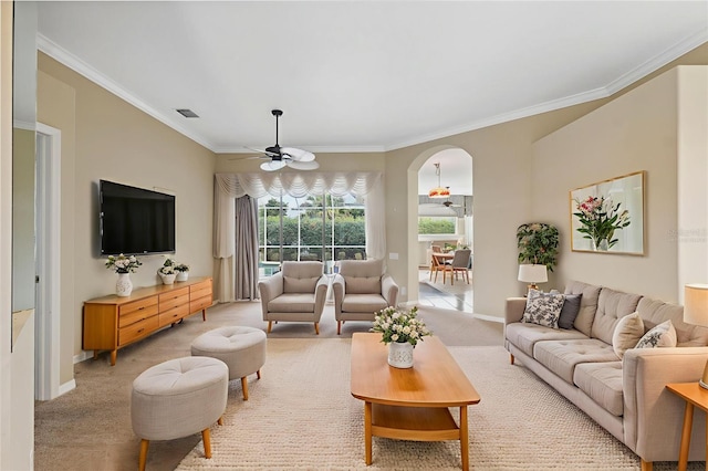 6112 Kinlock Ave, Spring Hill, FL 34608 - living room featuring a ceiling fan, arched walkways, crown molding, and light colored carpet