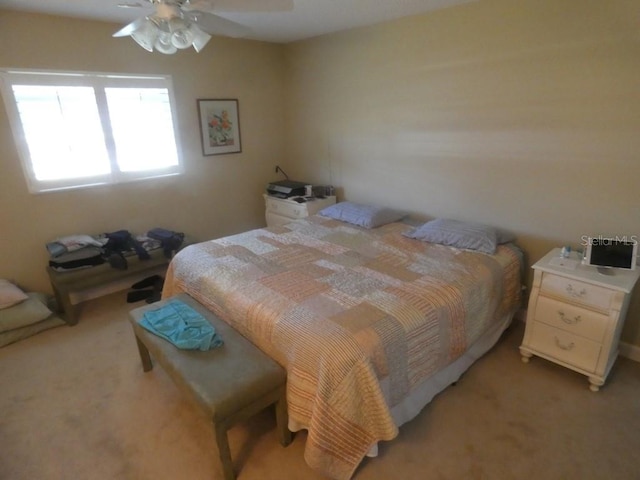 bedroom featuring light colored carpet and ceiling fan