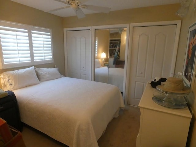 bedroom featuring two closets and ceiling fan