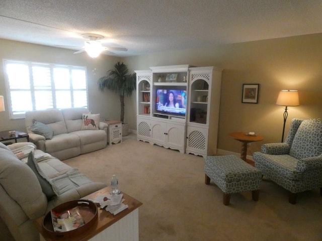 carpeted living room with ceiling fan and a textured ceiling