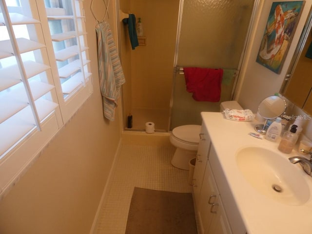 full bath featuring toilet, a shower stall, vanity, tile patterned flooring, and baseboards