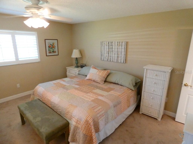 bedroom featuring carpet floors, baseboards, and a ceiling fan