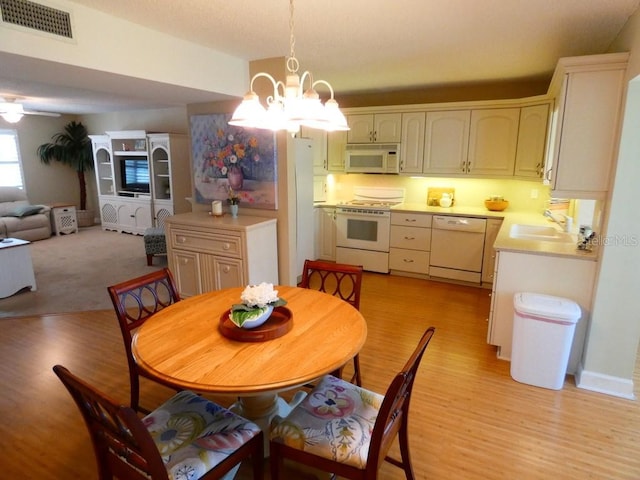 dining space with light wood-style floors, visible vents, and a notable chandelier