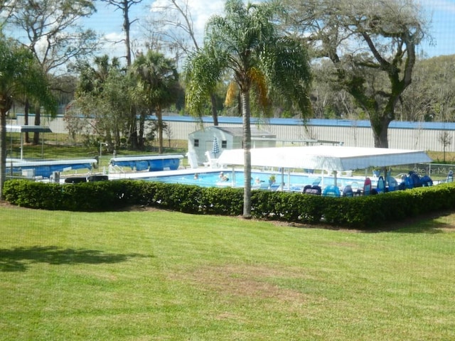 pool with a yard and fence