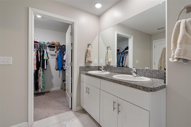 bathroom featuring tile patterned flooring and vanity