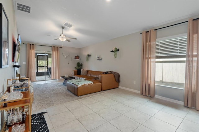 tiled living room with ceiling fan