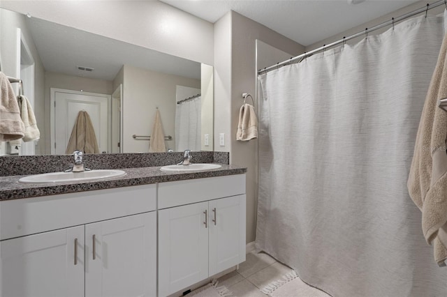 bathroom with tile patterned floors and vanity