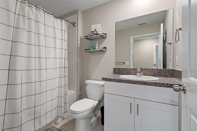 full bathroom featuring vanity, shower / bath combo, and toilet