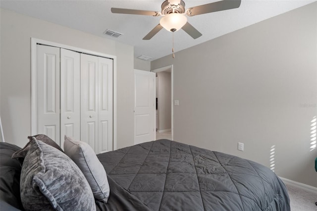 bedroom with carpet, ceiling fan, and a closet