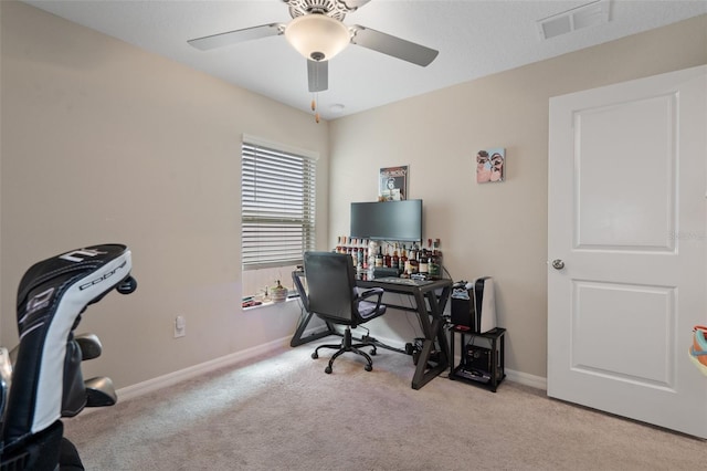 carpeted office space with ceiling fan