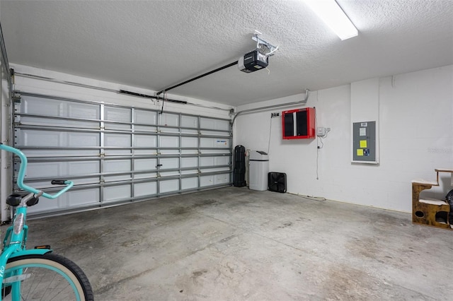 garage with a garage door opener and electric panel