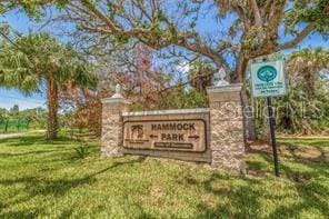 community / neighborhood sign with a yard