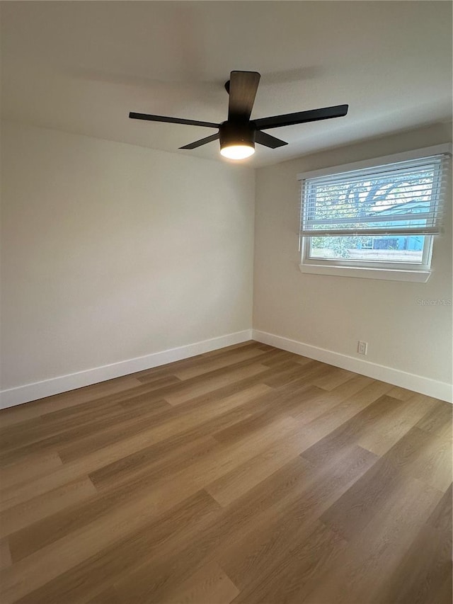 empty room with hardwood / wood-style flooring and ceiling fan