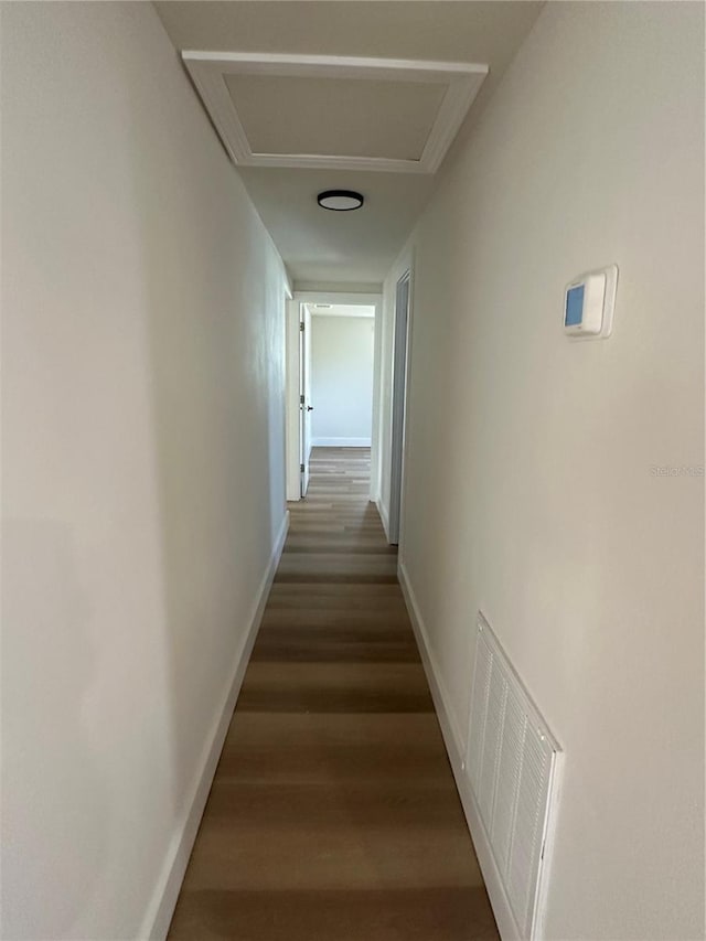 corridor with dark hardwood / wood-style flooring