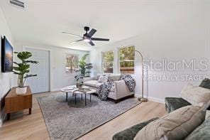 living room featuring light hardwood / wood-style flooring and ceiling fan