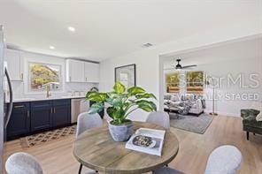 dining space featuring ceiling fan and light hardwood / wood-style floors