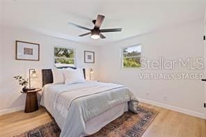 bedroom with wood-type flooring and ceiling fan