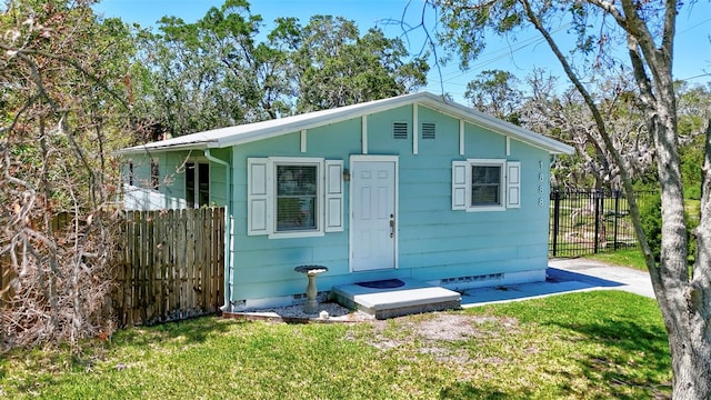 view of outbuilding featuring fence