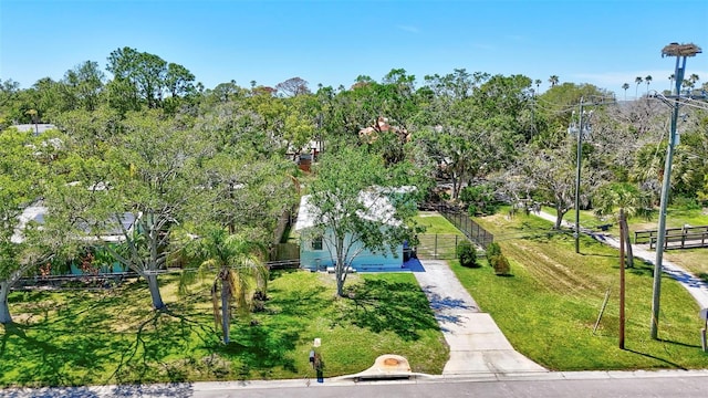 view of property's community with a yard and fence