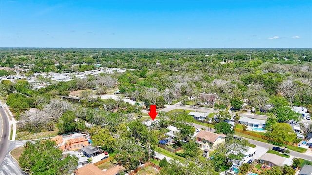 drone / aerial view with a residential view and a view of trees