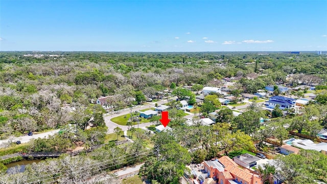 birds eye view of property featuring a residential view and a wooded view