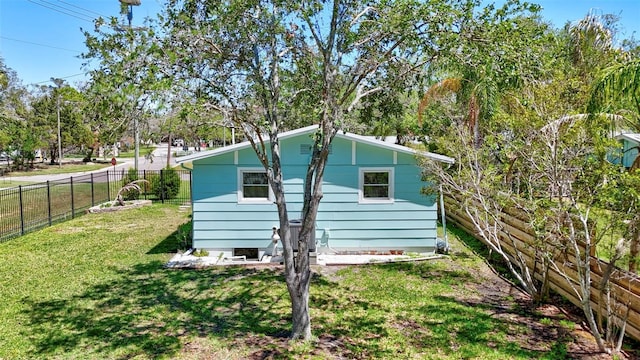 view of side of home with a yard and a fenced backyard
