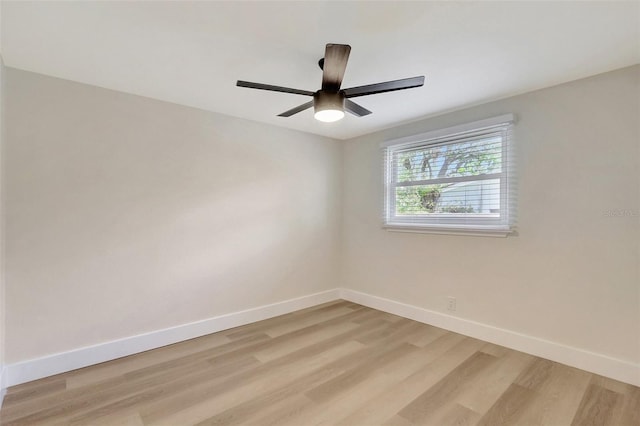 empty room with light wood-type flooring, a ceiling fan, and baseboards