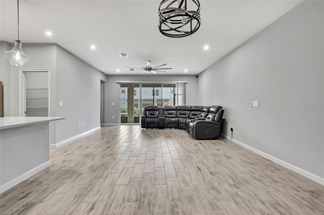 living room featuring ceiling fan and light hardwood / wood-style flooring