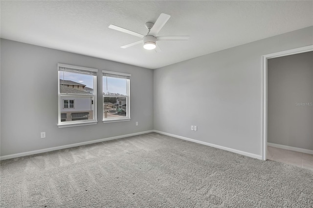 carpeted empty room with a textured ceiling and ceiling fan