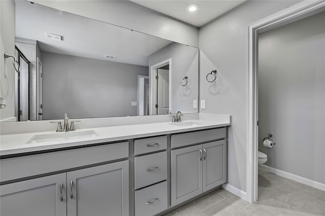 bathroom with vanity, tile patterned flooring, and toilet