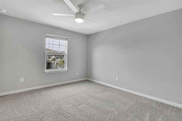 carpeted spare room with ceiling fan