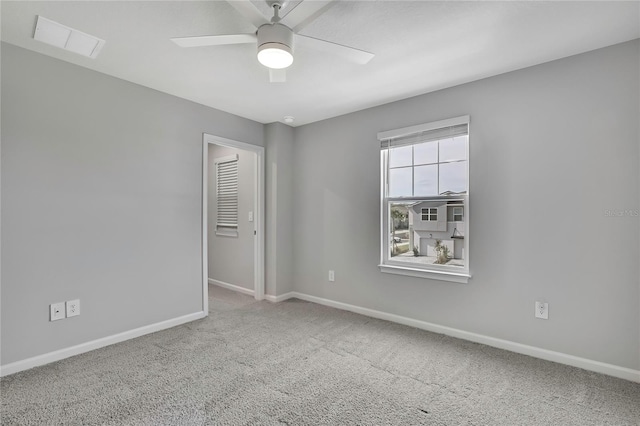 spare room with ceiling fan and carpet