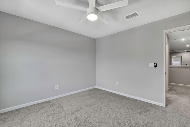 spare room with ceiling fan and light colored carpet