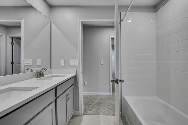 bathroom featuring tile patterned flooring, vanity, and tiled shower / bath