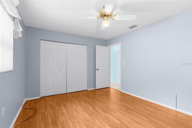 unfurnished bedroom featuring a closet, ceiling fan, and light hardwood / wood-style flooring