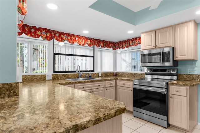 kitchen with sink, light brown cabinets, a healthy amount of sunlight, and appliances with stainless steel finishes