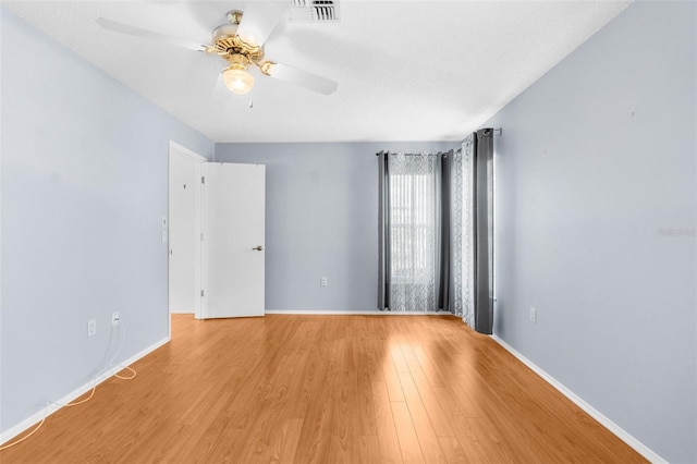 empty room with light hardwood / wood-style flooring and ceiling fan