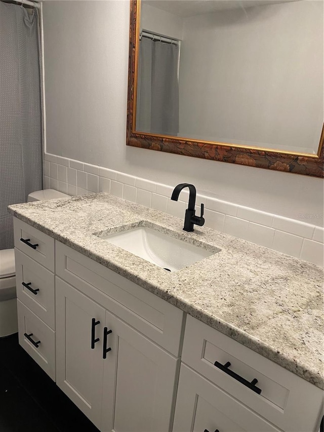 bathroom with vanity and toilet