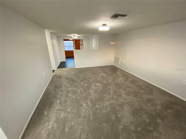 empty room with dark carpet