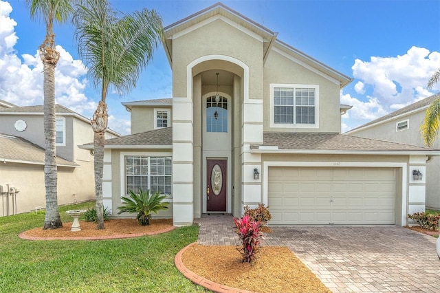 front of property featuring a garage and a front yard