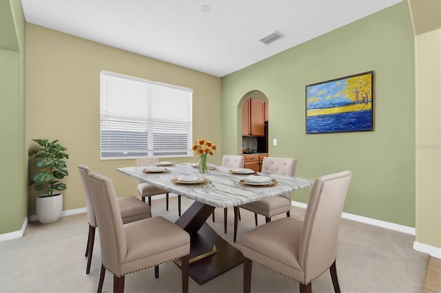 dining room with light colored carpet