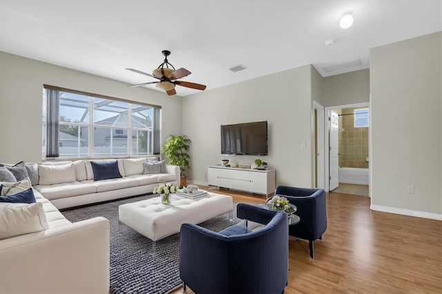 living room featuring hardwood / wood-style flooring and ceiling fan