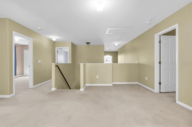 unfurnished room featuring light carpet