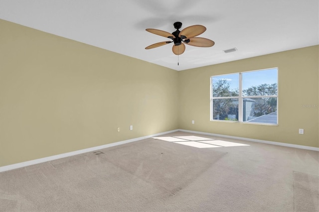 spare room with carpet floors and ceiling fan