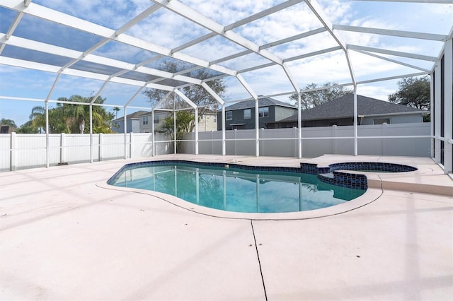 view of swimming pool featuring a patio area, an in ground hot tub, and glass enclosure