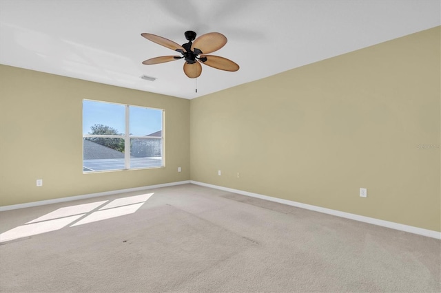 unfurnished room with light colored carpet and ceiling fan